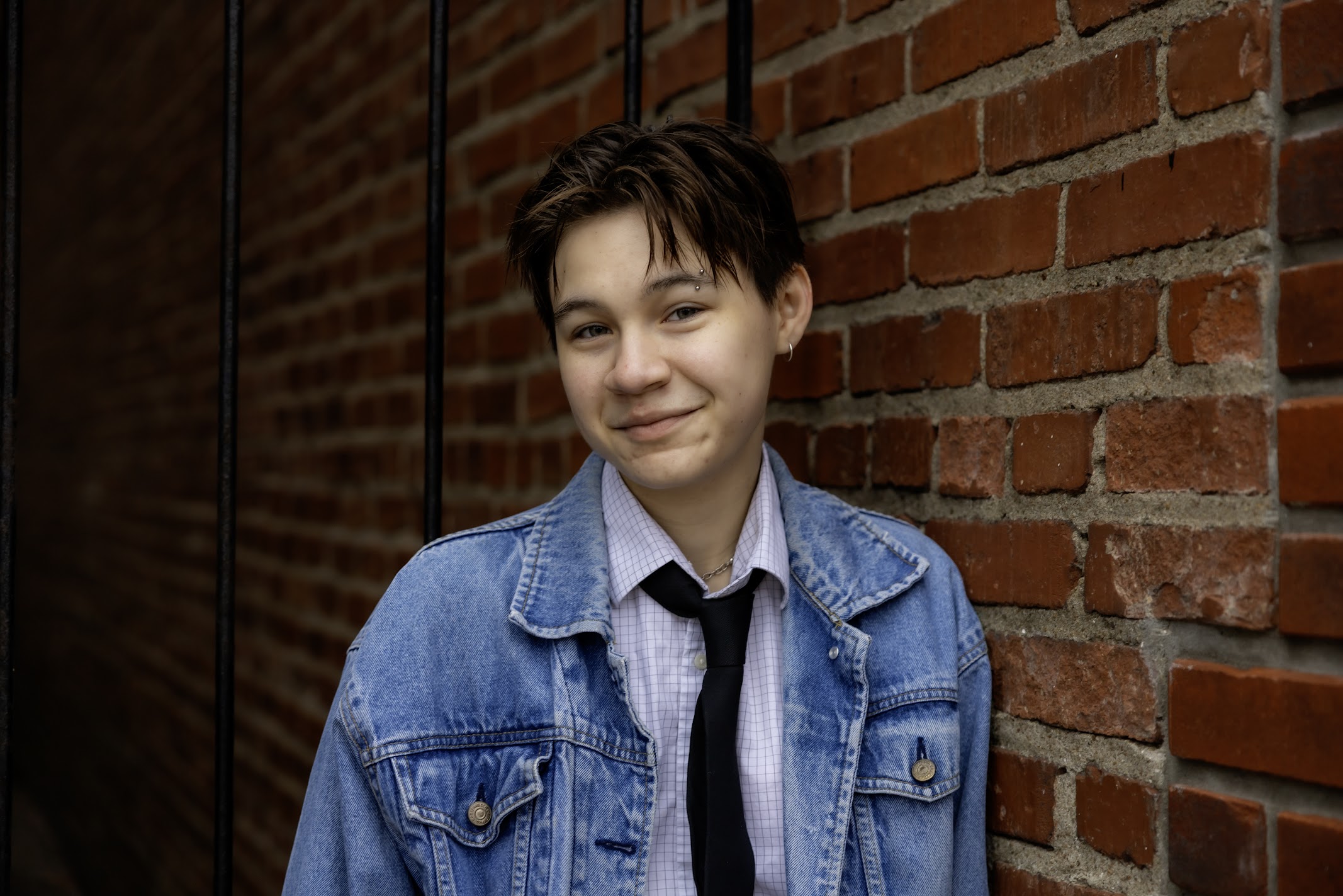 OCTA board member Lane Coukoulis in a denim jacket, button down shirt and tie